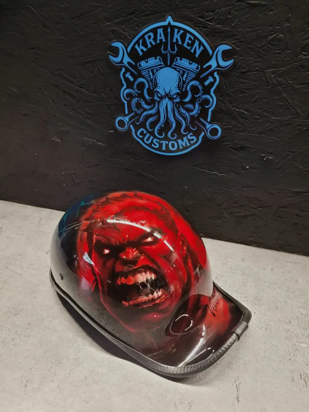 Kask orzeszek z czerwonym airbrushem rozwścieczonej twarzy